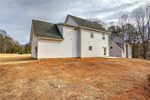 view of home's exterior featuring roof with shingles