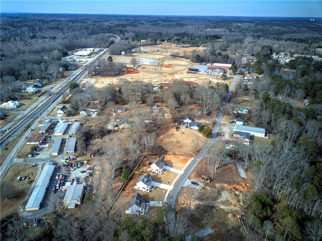 birds eye view of property with a wooded view