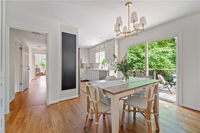 6960 Hunters Branch Dr, Atlanta, GA 30328 - dining space featuring light wood-style floors and a chandelier