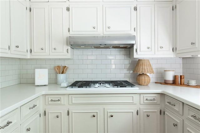 6960 Hunters Branch Dr, Atlanta, GA 30328 - kitchen featuring under cabinet range hood, light countertops, and white cabinetry