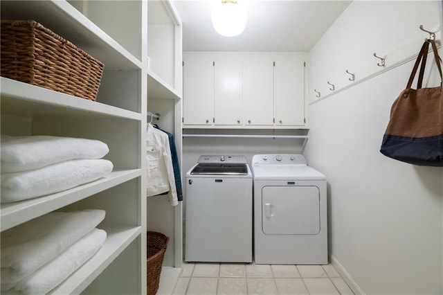 6960 Hunters Branch Dr, Atlanta, GA 30328 - laundry room featuring washer and clothes dryer, cabinet space, and light tile patterned floors