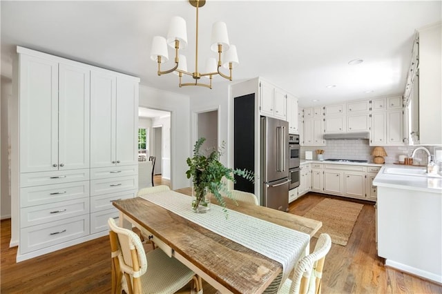 6960 Hunters Branch Dr, Atlanta, GA 30328 - dining space featuring wood finished floors, a chandelier, and recessed lighting