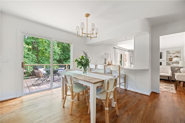6960 Hunters Branch Dr, Atlanta, GA 30328 - dining room featuring light wood-style flooring and a chandelier