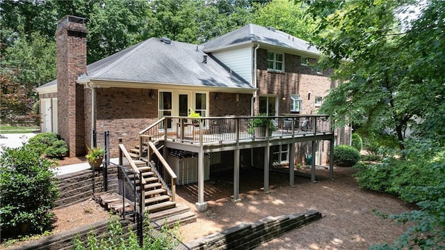 6960 Hunters Branch Dr, Atlanta, GA 30328 - back of property with stairway, a chimney, a wooden deck, a garage, and brick siding