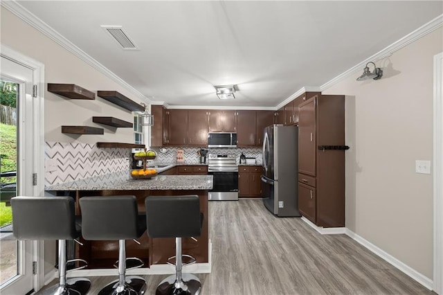 3208 Navajo Cir, Gainesville, GA 30501 - kitchen with appliances with stainless steel finishes, a peninsula, backsplash, light wood finished floors, and a sink