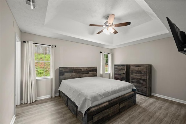 3208 Navajo Cir, Gainesville, GA 30501 - bedroom with a raised ceiling, wood finished floors, baseboards, and a ceiling fan
