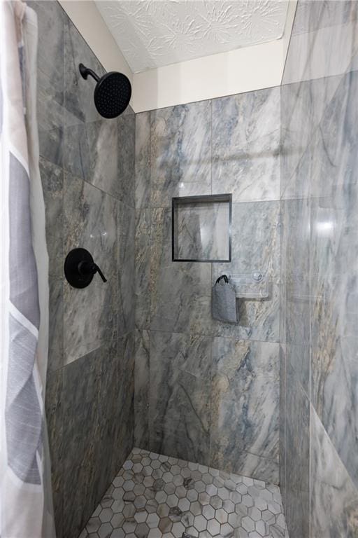 3208 Navajo Cir, Gainesville, GA 30501 - bathroom with a tile shower and a textured ceiling