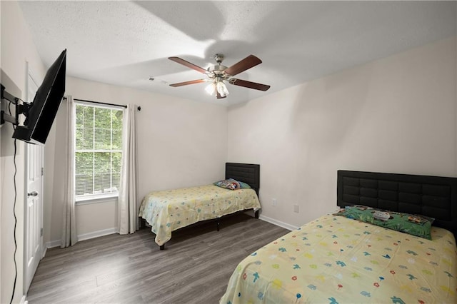 3208 Navajo Cir, Gainesville, GA 30501 - bedroom with wood finished floors, baseboards, and a ceiling fan