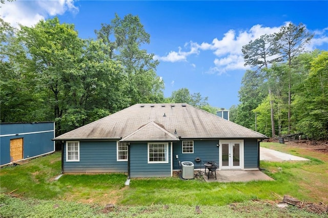 3208 Navajo Cir, Gainesville, GA 30501 - rear view of house with cooling unit, a patio, a lawn, and french doors