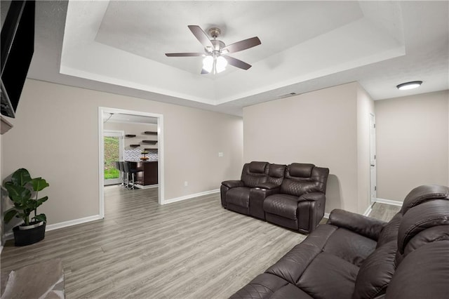 3208 Navajo Cir, Gainesville, GA 30501 - living room with a raised ceiling, baseboards, wood finished floors, and a ceiling fan