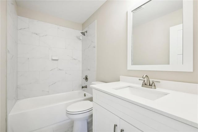 full bathroom featuring tiled shower / bath combo, toilet, and vanity