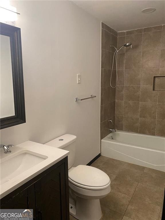 bathroom with tile patterned floors, toilet, vanity, and shower / tub combination