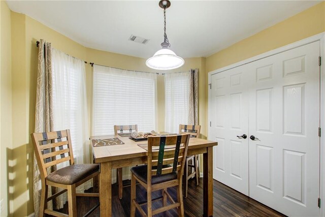 dining space with dark hardwood / wood-style flooring and a healthy amount of sunlight