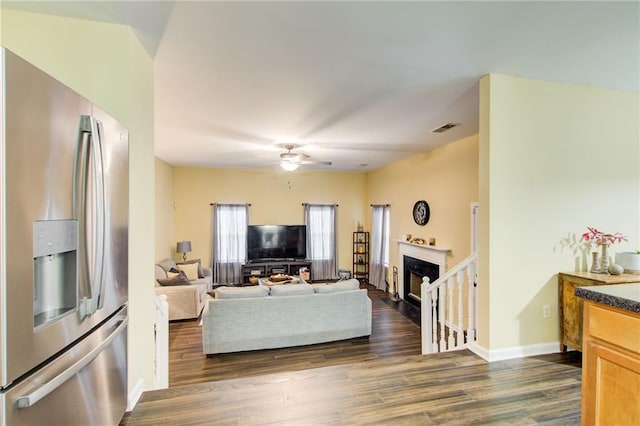 living room with ceiling fan and dark hardwood / wood-style flooring