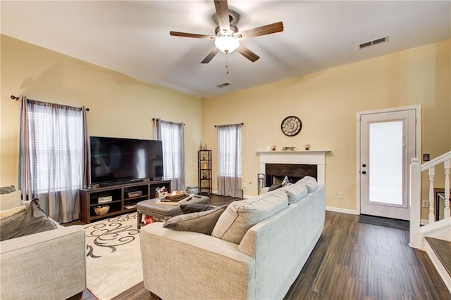 living room with dark hardwood / wood-style flooring and ceiling fan