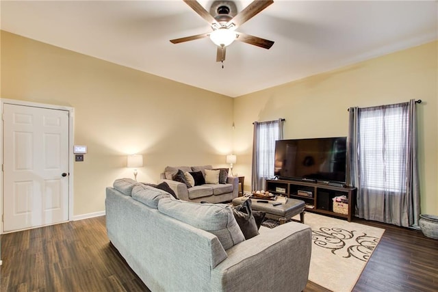 living room with ceiling fan and dark wood-type flooring