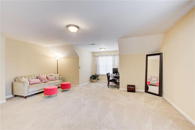 carpeted living room featuring vaulted ceiling