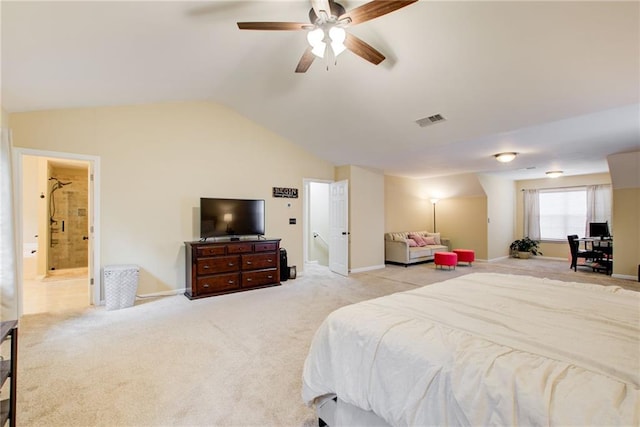 bedroom with ceiling fan, light colored carpet, lofted ceiling, and ensuite bathroom