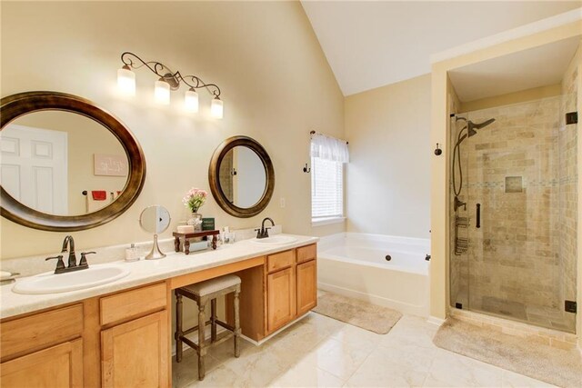 bathroom featuring vanity, shower with separate bathtub, and vaulted ceiling