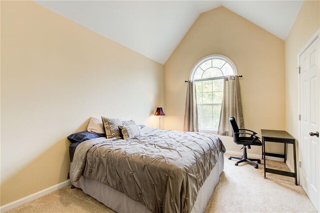 carpeted bedroom with vaulted ceiling