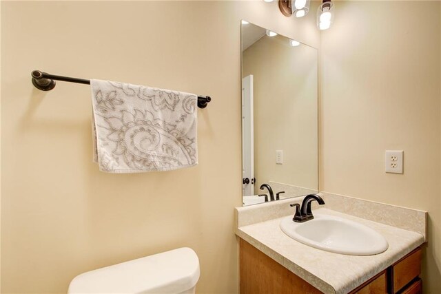 bathroom featuring vanity and toilet