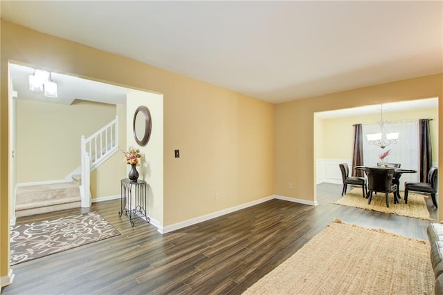 unfurnished room featuring dark hardwood / wood-style flooring and a chandelier