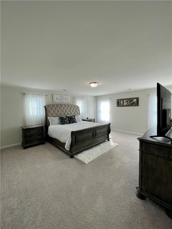 bedroom with light colored carpet