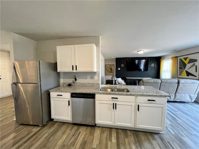 kitchen with white cabinetry, appliances with stainless steel finishes, and sink