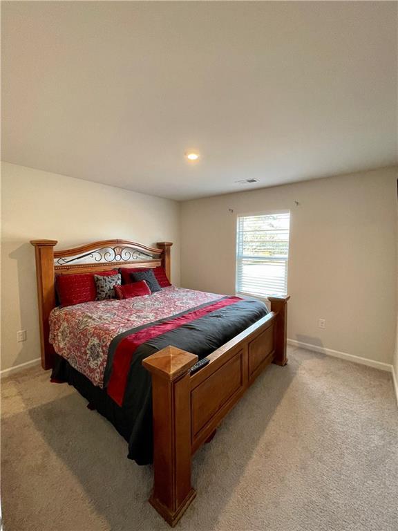 bedroom featuring light carpet