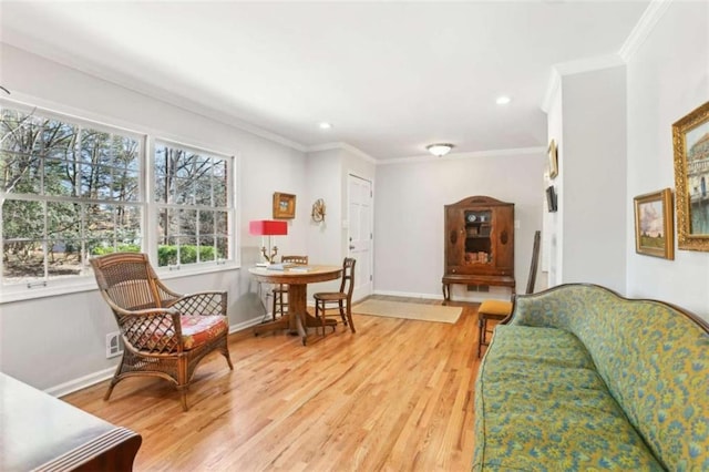 living room featuring hardwood / wood-style flooring and crown molding