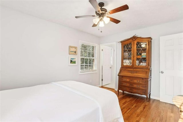 bedroom with wood-type flooring and ceiling fan