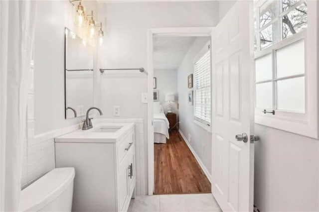 bathroom with vanity, tile patterned floors, and toilet