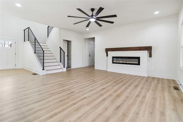 unfurnished living room with light wood-type flooring, ceiling fan, and crown molding