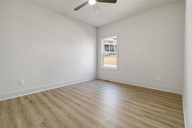 empty room featuring ceiling fan and light hardwood / wood-style floors