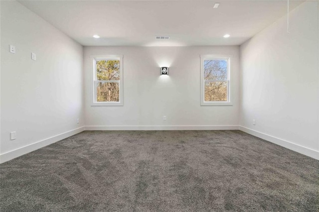 unfurnished room featuring dark carpet