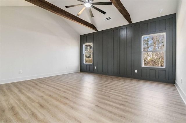 empty room featuring ceiling fan, high vaulted ceiling, beamed ceiling, and light hardwood / wood-style floors