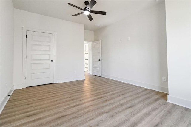 spare room featuring ceiling fan and light hardwood / wood-style flooring