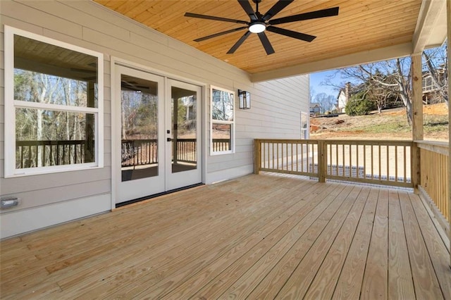 wooden deck with ceiling fan and french doors