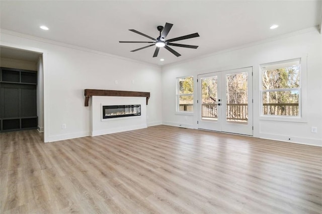 unfurnished living room featuring ceiling fan, crown molding, light hardwood / wood-style floors, and french doors