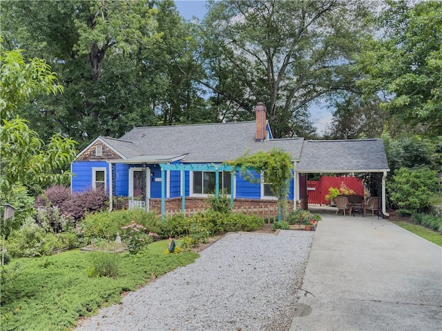 5130 Dearing St, Covington, GA 30014 - single story home featuring concrete driveway, brick siding, a chimney, an attached carport, and a shingled roof