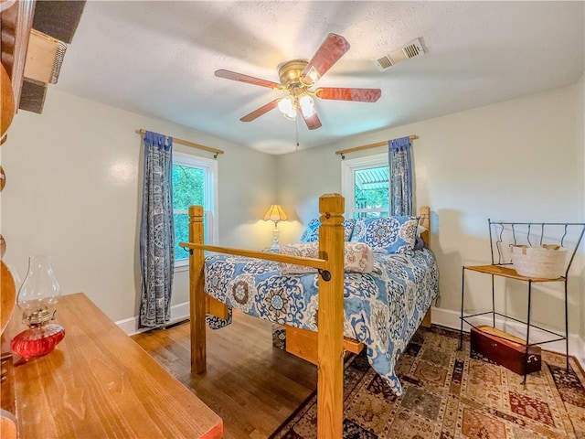 5130 Dearing St, Covington, GA 30014 - bedroom featuring multiple windows, wood finished floors, and a ceiling fan
