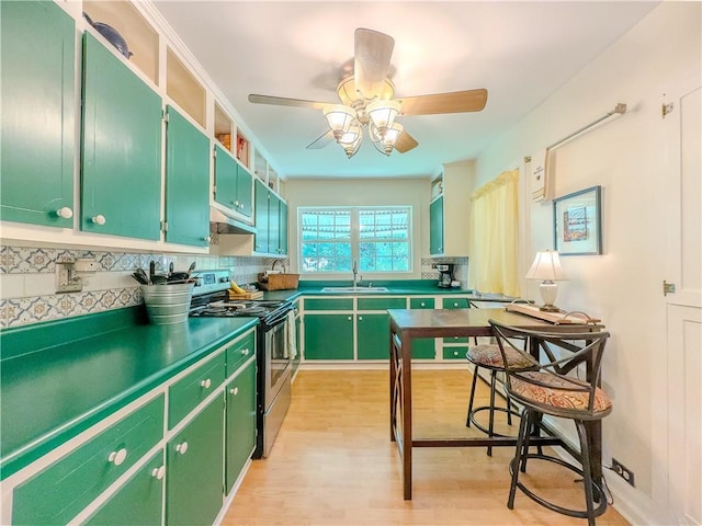 5130 Dearing St, Covington, GA 30014 - kitchen featuring electric range, light wood-type flooring, green cabinets, tasteful backsplash, and ceiling fan