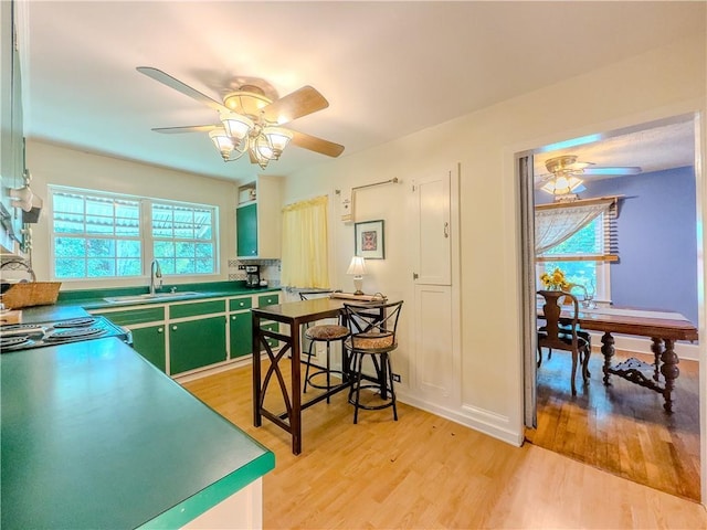 5130 Dearing St, Covington, GA 30014 - kitchen featuring a ceiling fan, healthy amount of natural light, light wood-style floors, and green cabinetry