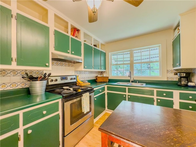 5130 Dearing St, Covington, GA 30014 - kitchen with stainless steel electric range oven, under cabinet range hood, and green cabinets