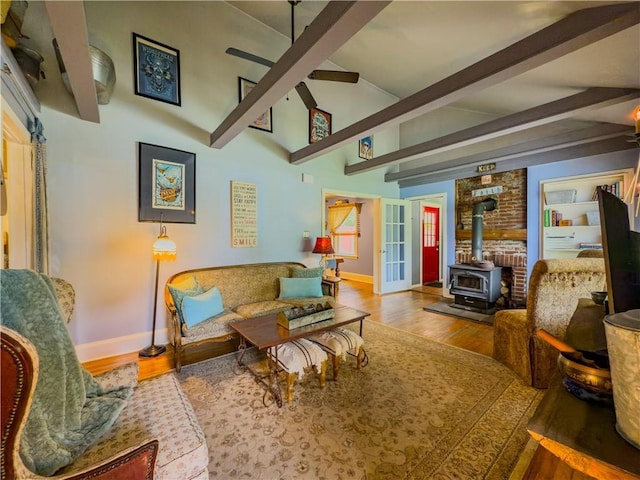 5130 Dearing St, Covington, GA 30014 - living room featuring a wood stove, wood finished floors, and a ceiling fan