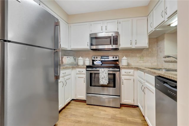 kitchen featuring white cabinetry, appliances with stainless steel finishes, and sink