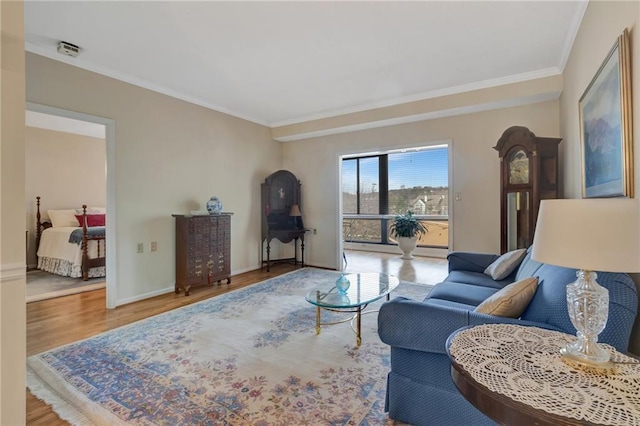 living room featuring hardwood / wood-style floors and crown molding