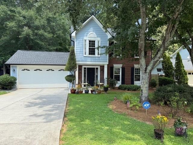 3545 Manchester Dr, Lawrenceville, GA 30044 - traditional-style home featuring driveway, a front lawn, a garage, and brick siding
