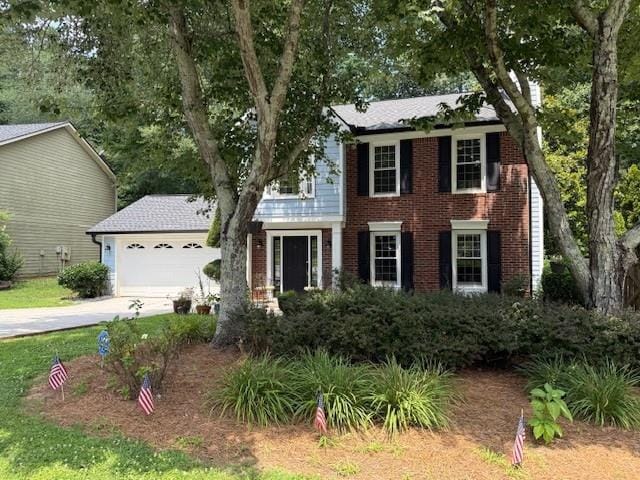3545 Manchester Dr, Lawrenceville, GA 30044 - colonial-style house with concrete driveway, an attached garage, and brick siding