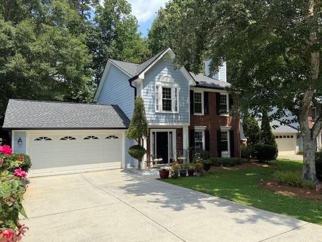 3545 Manchester Dr, Lawrenceville, GA 30044 - view of front of house featuring a garage, driveway, a chimney, and a front lawn